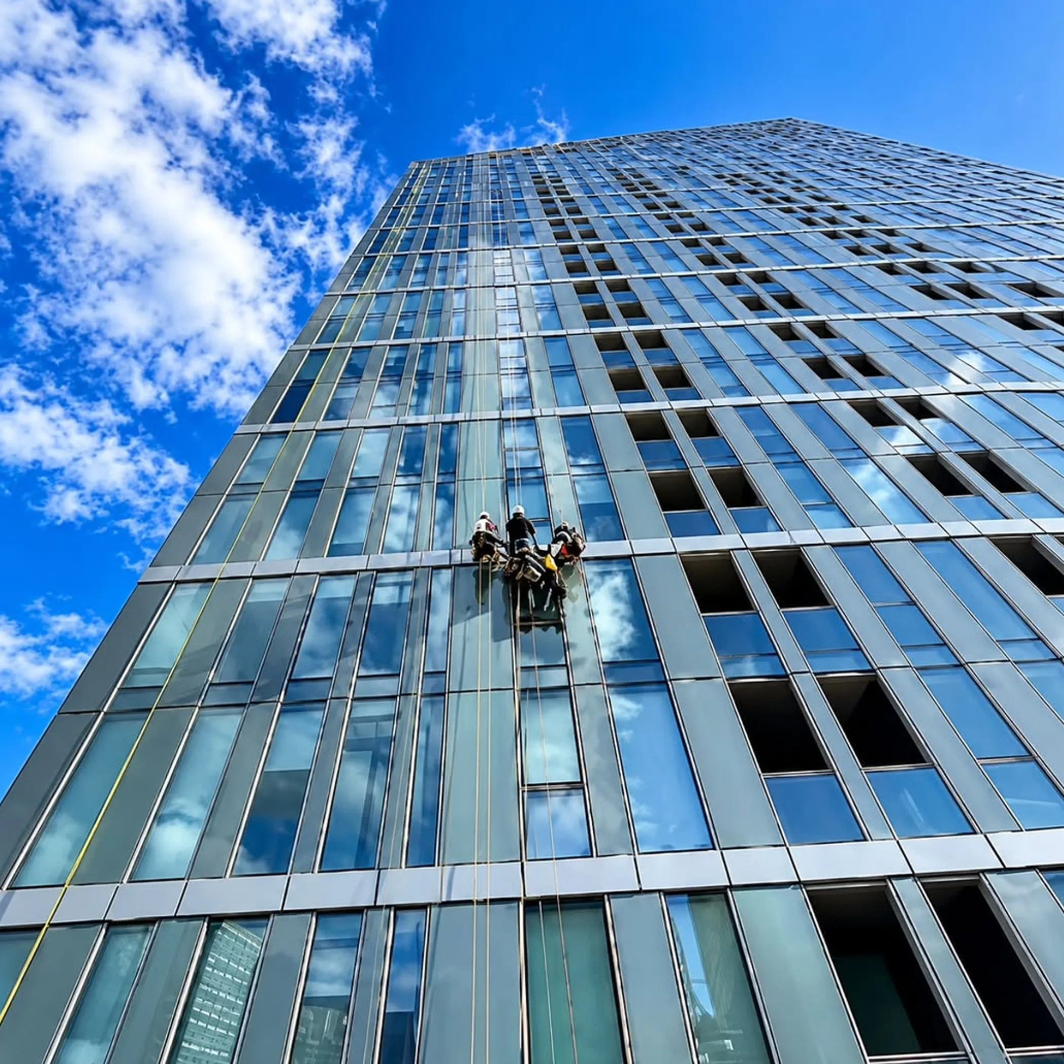 technicians working at height on high-rise building